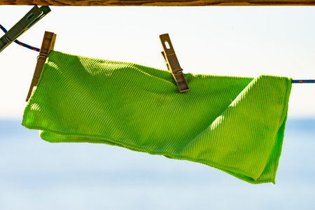 Camping on the beach, adventure concept. Cloth laundry hanging to dry on clothesline outdoor on beach against blue sea water.の写真素材