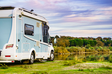 Camping on nature. Camper vehicle at lake shore. Povoa e Meadas Dam in Castelo de Vide, Alentejo Portugal. Travel in motor home.の写真素材