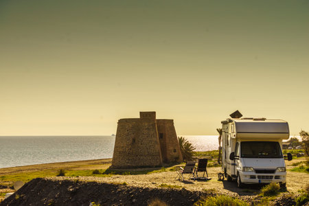 Rv caravan at historic castle of Macenas on the Mediterranean beach of Mojacar, spanish coast. Almeria province, Andalusia Spain.の写真素材