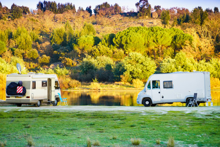 Camper vehicles camping on nature. Povoa e Meadas Dam in Castelo de Vide, Alentejo Portugal. Travel in motor home.の写真素材