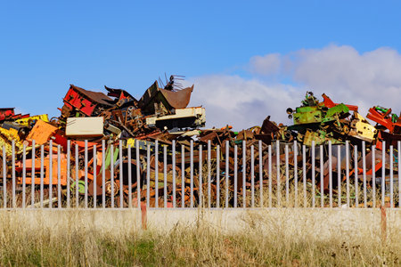 Huge pile of scrap metal junk garbage with blue sky backgroundの写真素材