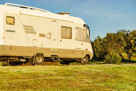 Camper car with external thermal screen blind at front windscreen. Camping on nature. Holidays and travel in motor home.の写真素材