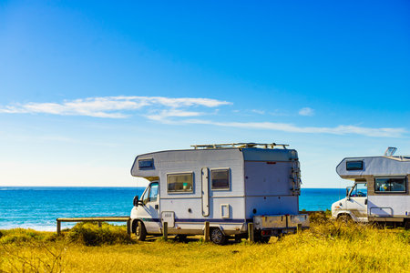Camper cars rv camping on beach sea shore, sunny summer day. Spain Murcia region, Calblanque Regional Park.の写真素材