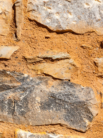Wall made of stone bricks. Texture, background in the ancient style. Architectural details of Greece.の写真素材