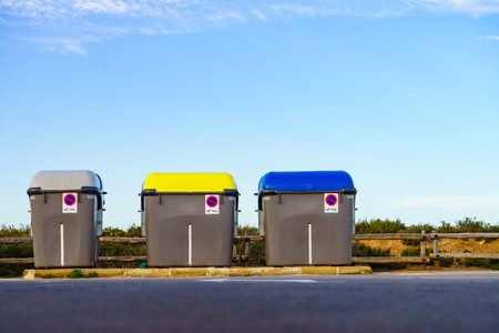 Industrial big garbage bins outdoors on coastal parking placeの写真素材