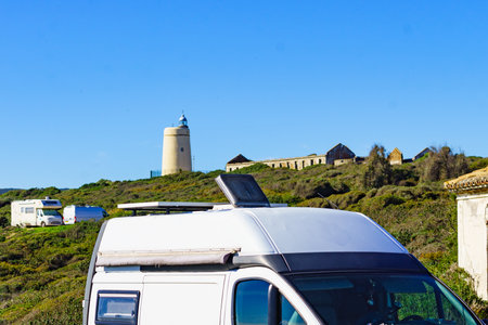Caravan on mediterranean Costa del Sol coast at lighthouse Carbonera, La Alcaidesa, Spain. Vacation trip, travel in mobile home.の写真素材