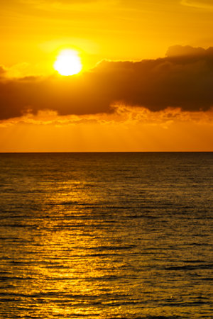 Seascape. Sunrise over sea water. Sun rising above the horizon.の写真素材