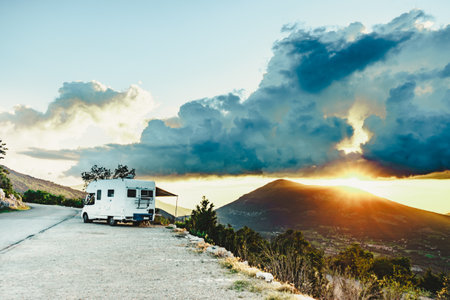 Caravan rv at sunset in mountains. Adventure with camper vehicle..の写真素材