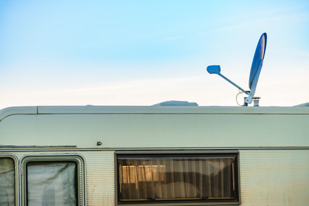 Satellite dish on roof of camper vehicle. TV connection. Travel holidays in motor home.の写真素材