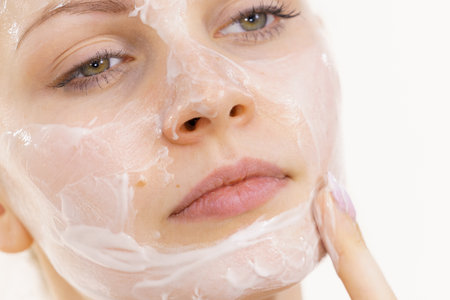 Young woman applying cream cosmetic, mask moisturizing to her face. beauty treatment. skincare.の写真素材