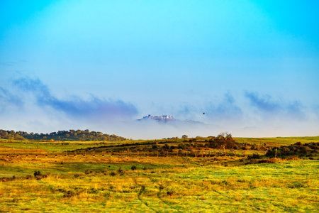 Town on hill, view from village Aldeia da Luz, Alentejo tourist destination region, district of Evora, Portugal.の写真素材