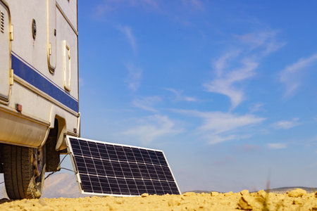 Portable solar photovoltaic panel, charging battery at camper car rv. Camping on nature, van life.の写真素材