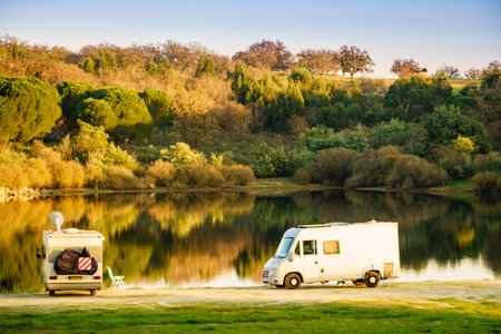 Camping on nature. Camper vehicle at lake shore. Povoa e Meadas Dam in Castelo de Vide, Alentejo Portugal. Travel in motor home.の写真素材