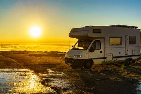 Caravan rv above clouds at sunrise. Motor home camping car in mountain nature in Portugal. Adventure with camper vehicle.の写真素材