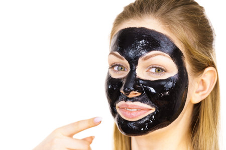 Young woman with cosmetic on face, carbo detox black peel off mask. spa treatment. skincare.の写真素材