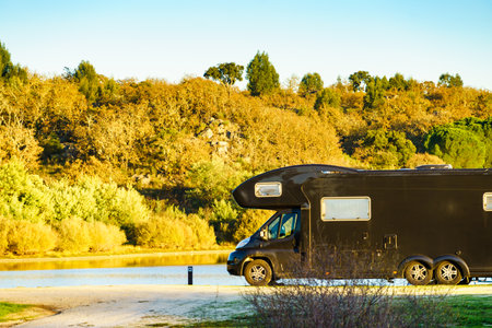 Camping on nature. Camper vehicle at lake shore. Povoa e Meadas Dam in Castelo de Vide, Alentejo Portugal. Travel in motor home.の写真素材