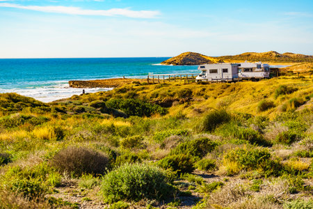 Sea coast view with camper car rv camping on beach. Spain Murcia region, Calblanque Regional Park.の写真素材