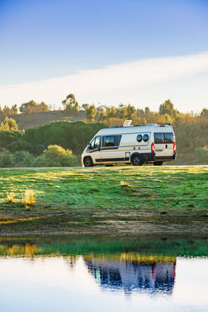 Camping on nature. Camper van at lake shore. Povoa e Meadas Dam in Castelo de Vide, Alentejo...