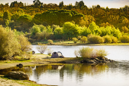 Tent on lakeshore. Camping on nature in summer. Povoa e Meadas Dam in Castelo de Vide, Alentejo Portugal.の写真素材