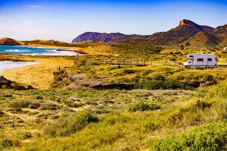 Sea coast view with camper car rv camping on beach. Spain Murcia region, Calblanque Regional Park.の写真素材