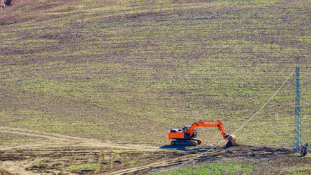 Digger excavator working on field.の写真素材