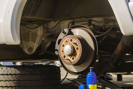 Car in service repairing. Detail of wheel assembly on automobile. Auto brake systemの写真素材