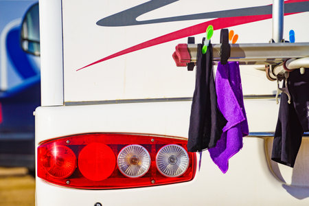 Camping on nature. Camper rv with clothes hanging to dry on back rack. Holidays with motor home.の写真素材