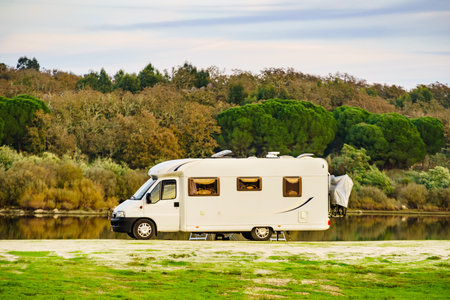 Camping on nature. Camper vehicle at lake shore. Povoa e Meadas Dam in Castelo de Vide, Alentejo Portugal. Travel in motor home.の写真素材