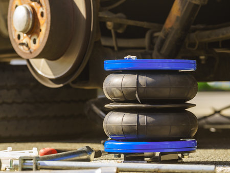 Installing auto air ride suspension. Car in service.の写真素材