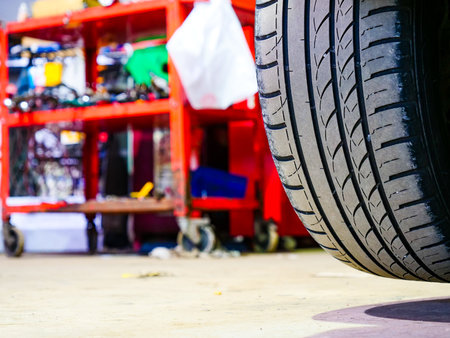 Car in service repairing. Detail of wheel assembly on automobile.の写真素材