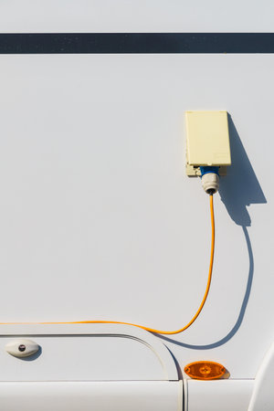 RV electrical cord plug power recharging travel trailer motorhome, electric connection from campsite.の写真素材
