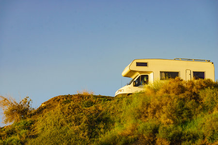 Camping on sea shore. Camper vehicle on cliff, mediterranean coast in Spain.の写真素材