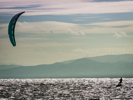 Kiteboarding. Kite surfer rides waves, Tarifa, Cadiz in Spain. Sports activities. Kitesurfing action.の写真素材