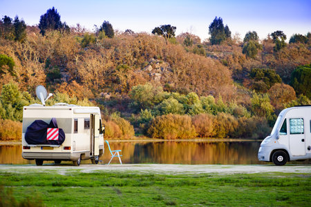 Camping on nature. Camper vehicle at lake shore. Povoa e Meadas Dam in Castelo de Vide, Alentejo Portugal. Travel in motor home.の写真素材