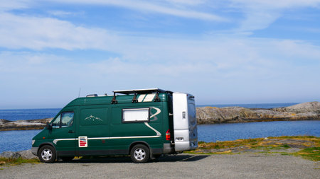 Camping and traveling concept. Camper van with storage box on Norwegian sea coastの写真素材
