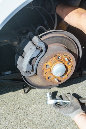 Car in service repairing. Detail of wheel assembly on automobile. Auto brake systemの写真素材