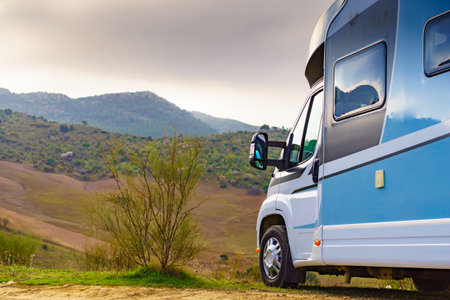 Camper vehicle camping in mountain nature. holiday trip.の写真素材