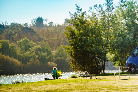 Camping on nature. Camper van at lake shore. Povoa e Meadas Dam in Castelo de Vide, Alentejo Portugal. Travel in motor home.の写真素材