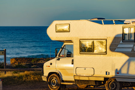 Camper car rv camping on beach sea shore, morning sun light. Spain Murcia region, Calblanque Regional Park.の写真素材