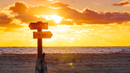 Sign in spanish at beach navigate lesson surfing school and kitesurfing. Sports activities.