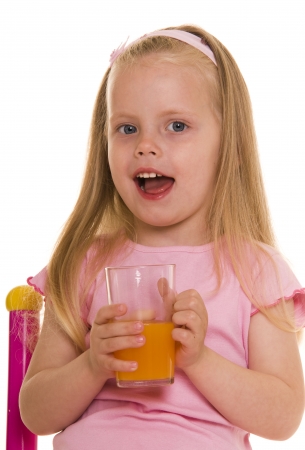 Little girl with glass of juice.の写真素材