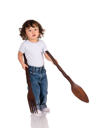 child with big spoon and forkの写真素材