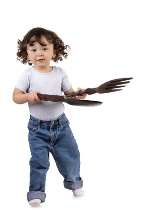 child with big spoon and forkの写真素材