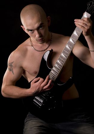 Portrait of the guitarist on a black backgroundの写真素材