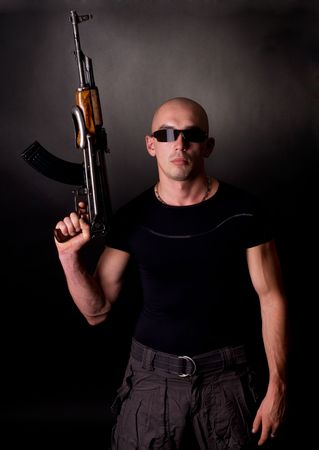 Men with gun on blackの写真素材