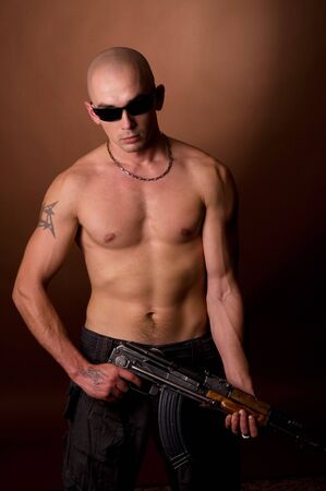 Men with gun on brownの写真素材