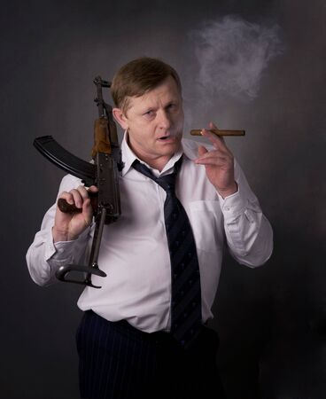Men with gun and cigarの写真素材