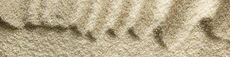 Banner horizontal sandy light background format 4:1 with waves of sand macro photographyの写真素材