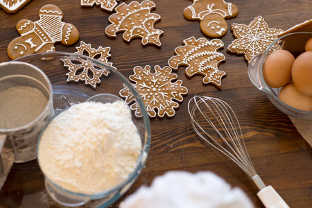 Still life with Christmas ginger cookies and ingredients for its baking - flour, eggs, sugarの写真素材