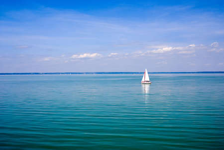 Blue landscape with sailboatの写真素材